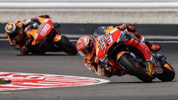 Repsol Honda Teamx92s Spanish rider Marc Marquez (R) and his teammate Spanish rider Jorge Lorenzo (L) take a corner during the first MotoGP free practice at the Sepang International Circuit on November 1, 2019, ahead of the Malaysian motorcycle Grand Prix. (Photo by Mohd RASFAN / AFP)
