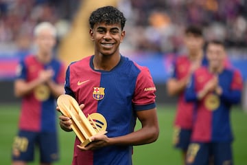 Barcelona's Spanish forward #19 Lamine Yamal receives the KOPA trophy for best under-21 player before the start the Spanish league football match between FC Barcelona and RCD Espanyol at the Estadi Olimpic Lluis Companys in Barcelona, on November 3, 2024. (Photo by Josep LAGO / AFP)