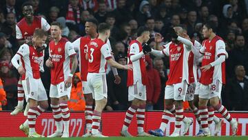 Arsenal's Norwegian midfielder Martin Odegaard (L) celebrates with teammates after scoring their second goal during the English Premier League football match between Arsenal and Southampton at the Emirates Stadium in London on December 11, 2021. (Pho
