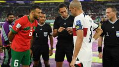 DOHA, QATAR - DECEMBER 10: Romain Saiss of Morocco and Pepe of Portugal prepare for the coin toss with referee Facundo Tello and match officials prior to the FIFA World Cup Qatar 2022 quarter final match between Morocco and Portugal at Al Thumama Stadium on December 10, 2022 in Doha, Qatar. (Photo by David Ramos - FIFA/FIFA via Getty Images)