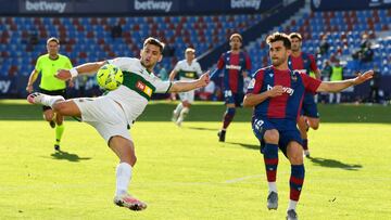 VALENCIA, SPAIN - NOVEMBER 21: Lucas Boye of Elche CF is challenged by Sergio Postigo of Levante UD during the La Liga Santander match between Levante UD and Elche CF at Ciutat de Valencia Stadium on November 21, 2020 in Valencia, Spain. Football Stadiums