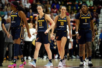 Aliyah Boston #7, Caitlin Clark #22, Lexie Hull #10 and NaLyssa Smith #1 walk the court during a timeout 