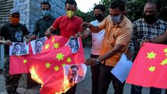 Activists of Bajrang Dal and Vishva Hindu Parishad (VHP) organisations burn Chinese flags and posters of Chinese President Xi Jinping, during an anti-China protest in Amritsar on June 17, 2020. - India and China held top level talks on June 17 to &quot;co