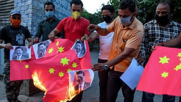 Activists of Bajrang Dal and Vishva Hindu Parishad (VHP) organisations burn Chinese flags and posters of Chinese President Xi Jinping, during an anti-China protest in Amritsar on June 17, 2020. - India and China held top level talks on June 17 to &quot;co