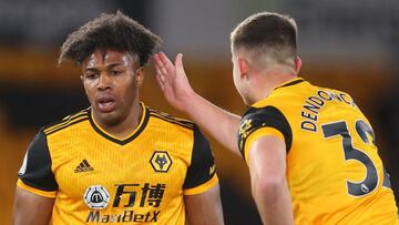 Wolverhampton Wanderers' Belgian midfielder Leander Dendoncker (R) taps Wolverhampton Wanderers' Spanish midfielder Adama Traore on the shoulder during the English Premier League football match between Wolverhampton Wanderers and Leeds United at