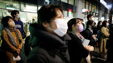 Voters wearing protective face masks listen to a speech by a candidate during an election campaign on the first day of campaigning for the upcoming lower house election, amid the coronavirus disease (COVID-19) pandemic, in Tokyo, Japan October 19, 2021.  