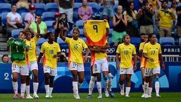 Colombia's midfielder #08 Marcela Restrepo (C) holds up a jersey of Colombia's forward #09 Mayra Ramirez after scoring the opening goal during the women's group A football match between New Zealand and Colombia of the Paris 2024 Olympic Games at the Lyon Stadium in Lyon on July 28, 2024. (Photo by Olivier CHASSIGNOLE / AFP)