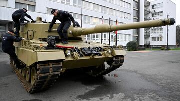FILE PHOTO: Members of the military walk on a tank, as Germany delivers its first Leopard tanks to Slovakia as part of a deal after Slovakia donated fighting vehicles to Ukraine, in Bratislava, Slovakia, December 19, 2022. REUTERS/Radovan Stoklasa/File Photo