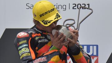 Motorcycling - MotoGP - German Grand Prix - Sachsenring, Hohenstein-Ernstthal, Germany - June 20, 2021 Red Bull KTM Ajo's Remy Gardner celebrates with a trophy on the podium after winning the Moto2 race REUTERS/Matthias Rietschel