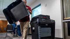 An election judge sets up a Dominion voting machine during a public accuracy test of voting equipment  in Burnsville, Minnesota.