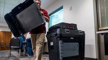 An election judge sets up a Dominion voting machine during a public accuracy test of voting equipment  in Burnsville, Minnesota.