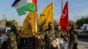 Members of Harakat Hezbollah al Nujaba, hold a Palestinian flag and other flags during a protest in solidarity with Palestinians in Gaza, in Baghdad, Iraq, October 8, 2023. REUTERS/Ahmed Saad