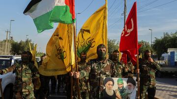 Members of Harakat Hezbollah al Nujaba, hold a Palestinian flag and other flags during a protest in solidarity with Palestinians in Gaza, in Baghdad, Iraq, October 8, 2023. REUTERS/Ahmed Saad