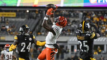 Jan 4, 2025; Pittsburgh, Pennsylvania, USA; Cincinnati Bengals wide receiver Tee Higgins (5) catches a pass in front of Pittsburgh Steelers cornerback Joey Porter Jr. (24) and safety DeShon Elliott (25) during the second quarter at Acrisure Stadium. Mandatory Credit: Barry Reeger-Imagn Images