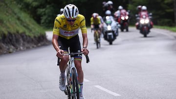 UAE Team Emirates XRG's Slovenian rider Tadej Poga?ar wearing the overall leader's yellow jersey cycles leading the race with Team Visma - Lease a Bike's Danish rider Jonas Vingegaard in the background during the 7th stage of the 77th edition of the Criterium du Dauphine cycling race, 131,6 km between Grand-Aigueblanche and Valmeinier, on June 14, 2025. (Photo by Anne-Christine POUJOULAT / AFP)