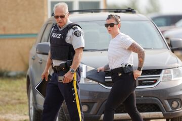 Royal Canadian Mounted Police (RCMP) officers at James Smith Cree Nation walk after multiple people were killed and injured in a stabbing spree on the reserve and nearby town of Weldon, Saskatchewan, Canada September 5, 2022.  REUTERS/David Stobbe