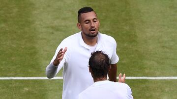 (FILES) In this file photo taken on July 4, 2019 Australia's Nick Kyrgios (top) shakes hands with Spain's Rafael Nadal (bottom) after Nadal won their men's singles second round match on the fourth day of the 2019 Wimbledon Championships at The All England Lawn Tennis Club in Wimbledon, southwest London. - Rafael Nadal and Nick Kyrgios will meet for a place in the Wimbledon final on July 8, 2022 in what the Australian star claims will be "the most watched tennis match ever." Nadal leads their series 6-3. AFP Sport looks at four of their most memorable matches in a rivalry which has been thrilling and often testy. (Photo by Daniel LEAL / AFP)