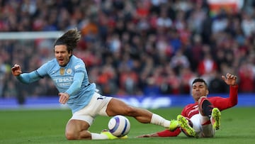 Manchester United's Brazilian midfielder #18 Casemiro (R) tackles Manchester United's English striker #10 Marcus Rashford (L) during the English Premier League football match between Manchester United and Manchester City at Old Trafford in Manchester, north west England, on April 6, 2025. (Photo by Darren Staples / AFP) / RESTRICTED TO EDITORIAL USE. No use with unauthorized audio, video, data, fixture lists, club/league logos or 'live' services. Online in-match use limited to 120 images. An additional 40 images may be used in extra time. No video emulation. Social media in-match use limited to 120 images. An additional 40 images may be used in extra time. No use in betting publications, games or single club/league/player publications. /