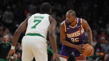 Phoenix Suns forward Kevin Durant (35) shields the ball from Boston Celtics guard Jaylen Brown (7) during the first half at Footprint Center.