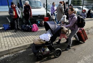 Ukrainian women and children wait to cross the border into Slovakia.