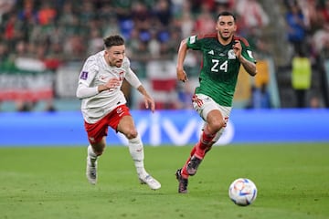 DOHA, QATAR - NOVEMBER 22: Matty Cash of Poland and Luis Chavez of Mexico battle for the ball during the FIFA World Cup Qatar 2022 Group C match between Mexico and Poland at Stadium 974 on November 22, 2022 in Doha, Qatar. (Photo by Harry Langer/DeFodi Images via Getty Images)