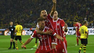 Bayern Munich's midfielder Joshua Kimmich (L) and his teammates celebrate after scoring during the German Supercup football match between Borussia Dortmund vs Bayern Munich in Dortmund, western Germany, on August 5, 2017. / AFP PHOTO / PATRIK STOLLARZ