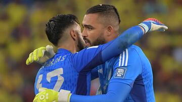 Colombia's goalkeeper Camilo Vargas and Colombia's goalkeeper Alvaro Montero embrace after the former was expelled for committing a penalty and leaves the field, during the 2026 FIFA World Cup South American qualification football match between Colombia and Uruguay at the Roberto Melendez Metropolitan Stadium in Barranquilla, Colombia, on October 12, 2023. (Photo by Raul ARBOLEDA / AFP) (Photo by RAUL ARBOLEDA/AFP via Getty Images)
