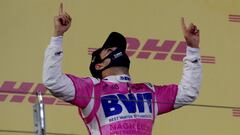 Formula One F1 - Sakhir Grand Prix - Bahrain International Circuit, Sakhir, Bahrain - December 6, 2020 Racing Point's Sergio Perez celebrates on the podium with the trophy after winning the race Pool via REUTERS/Tolga Bozoglu