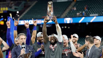 HOUSTON, TEXAS - OCTOBER 23: Adolis Garcia #53 of the Texas Rangers hoist the ALCS MVP Trophy after defeating the Houston Astros in Game Seven to win the American League Championship Series at Minute Maid Park on October 23, 2023 in Houston, Texas.   Carmen Mandato/Getty Images/AFP (Photo by Carmen Mandato / GETTY IMAGES NORTH AMERICA / Getty Images via AFP)