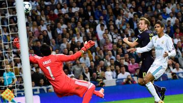 Real Madrid's French defender Raphael Varane (R) scores an own goal during the UEFA Champions League group H football match Real Madrid CF vs Tottenham Hotspur FC at the Santiago Bernabeu stadium in Madrid on October 17, 2017. / AFP PHOTO / PIERRE-PH
