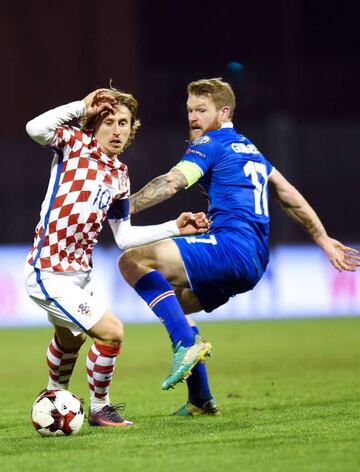 Iceland's midfielder Aron Gunarsson vies with Luka Modric during the 2018 World Cup football qualification match.