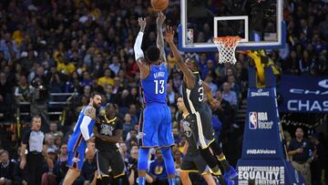 OAKLAND, CA - FEBRUARY 06: Paul George #13 of the Oklahoma City Thunder shoots a three-point shot over Kevin Durant #35 of the Golden State Warriors during the second half of their NBA basketball game at ORACLE Arena on February 6, 2018 in Oakland, Califo