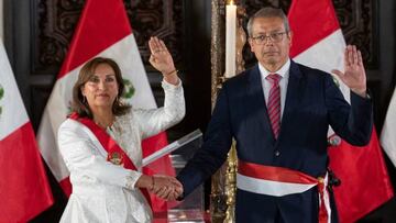 Peru's new President, Dina Boluarte (L), poses with Pedro Angulo, her newly sworn president of her ministerial team, during the swearing-in ceremony of the newly appointed cabinet ministers at the Palace of Government in Lima on December 10, 2022. - The head of Peru's legislature called on December 10, 2022, on the country's new leader Dina Boluarte to appoint a new cabinet urgently amid continuing street protests following the removal of Pedro Castillo as president. (Photo by Cris BOURONCLE / AFP) (Photo by CRIS BOURONCLE/AFP via Getty Images)