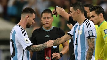Argentina's forward Lionel Messi (L) gives the captain's band to forward Angel Di Maria before leaving during the 2026 FIFA World Cup South American qualification football match between Brazil and Argentina at Maracana Stadium in Rio de Janeiro, Brazil, on November 21, 2023. (Photo by CARL DE SOUZA / AFP)