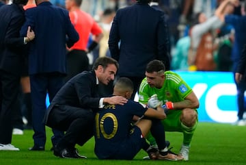 El presidente de Francia, Emmanuel Macron, y el portero de Argentina, Emiliano Martínez, intentan consolar a Mbappé tras perder la final de la Copa del Mundo.