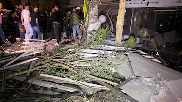 People gather near the site of an Israeli airstrike that targeted a residential building in the Mezzah suburb in western Damascus, according to Syrian state media, Syria October 2, 2024. REUTERS/Firas Makdesi
