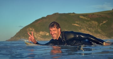 Ibon, saludando y sonriendo a la cmara montado en su tabla. Feliz de disfrutar del surf.