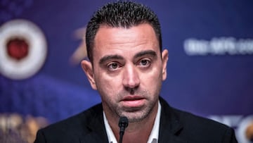 (FILES) In this file photo taken on December 2, 2019 Al Sadd SC Manager Xavier HernxE1ndez Creus, also known as Xavi, speaks to the media after receiving the Asian Football Confederation (AFC) Men's Player of the Year 2019 award in place of absentee