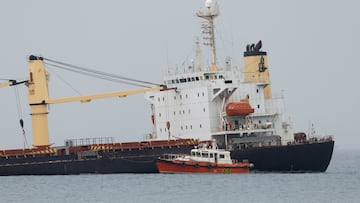 Crew members stand on the half sunken cargo ship OS 35 in Catalan Bay after its collision with LNG tanker ADAM LNG near Gibraltar, August 30, 2022. REUTERS/Jon Nazca