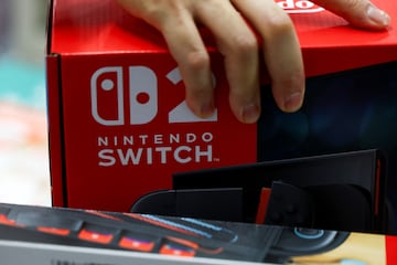 A person holds a Nintendo Switch 2 game console's box as Nintendo starts selling the new consoles globally, at an electronics store in Tokyo, Japan June 5, 2025. REUTERS/Issei Kato
