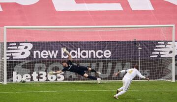 BILBAO, SPAIN - JULY 05: Unai Simon of Athletic Club tries to save the penalty struck by Sergio Ramos of Real Madrid CF during the Liga match between Athletic Club and Real Madrid CF at San Mames Stadium on July 05, 2020 in Bilbao, Spain.