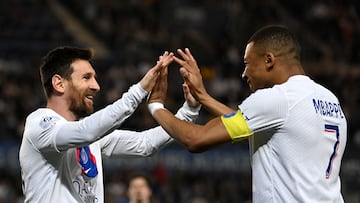 Paris Saint-Germain's Argentine forward Lionel Messi celebrates with Paris Saint-Germain's French forward Kylian Mbappe after scoring his team's first goal during the French L1 football match between RC Strasbourg Alsace and Paris Saint-Germain (PSG) at Stade de la Meinau in Strasbourg, eastern France on May 27, 2023. (Photo by Jean-Christophe Verhaegen / AFP)