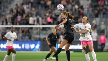 Jun 28, 2023; Los Angeles, CA, USA; Angel City FC midfielder Dani Weatherholt (17) heads the ball ahead of San Diego Wave FC midfielder Giovanna DeMarco (12) during the first half at BMO Stadium. Mandatory Credit: Jessica Alcheh-USA TODAY Sports