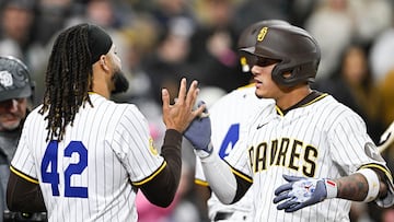Apr 15, 2025; San Diego, California, USA; San Diego Padres third baseman Manny Machado (13), right, is congratulated by Fernando Tatis Jr. (23) after hitting a solo home run during the fifth inning against the Chicago Cubs at Petco Park. Mandatory Credit: Denis Poroy-Imagn Images