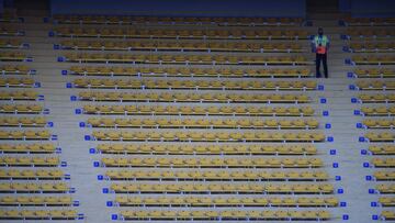 A security guard stands next to empty stands before the closed-door 2022 FIFA World Cup South American qualifier football match between Argentina and Paraguay at La Bombonera Stadium in Buenos Aires on November 12, 2020. (Photo by Marcelo Endelli / POOL /