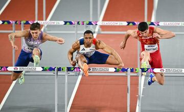 (From L) Britain's David King, France's Wilhem Belocian and Spain's Asier Martinez compete in the Men's 60m hurdles heat 2 during the Indoor World Athletics Championships in Glasgow, Scotland, on March 2, 2024. (Photo by Ben Stansall / AFP)