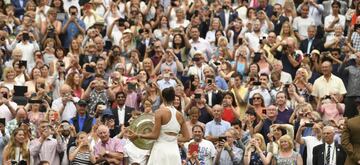 Spain's Garbine Muguruza shows the winners trophy