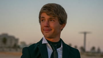 Nico Pardo en traje mirando al horizonte en una playa de Cádiz