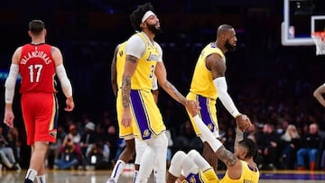 Feb 15, 2023; Los Angeles, California, USA; Los Angeles Lakers forward LeBron James (6) and forward Anthony Davis (3) help up guard D'Angelo Russell (1) against the New Orleans Pelicans during the second half at Crypto.com Arena. Mandatory Credit: Gary A. Vasquez-USA TODAY Sports