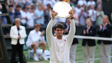 Tennis - Wimbledon - All England Lawn Tennis and Croquet Club, London, Britain - July 13, 2025 Runner up Spain's Carlos Alcaraz celebrates with the trophy after losing the men's final against Italy's Jannik Sinner REUTERS/Toby Melville